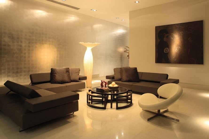 Sala moderna em tons neutros com estofados e poltrona