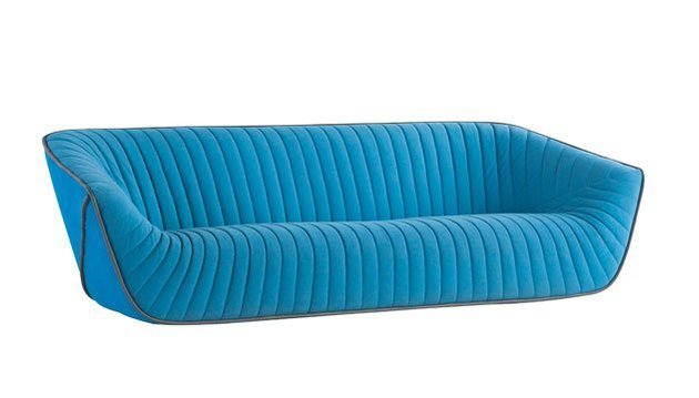 Sofá Nautil azul visto de três quartos, com o encosto inteiriço e sem almofadas soltas